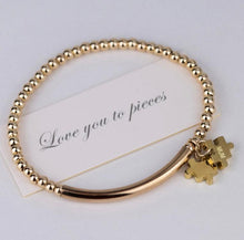 Load image into Gallery viewer, Gold beaded bracelet with two jigsaw shaped charms with personalised initials engraving And card saying I love you to pieced
