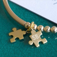 Load image into Gallery viewer, Gold beaded bracelet with two jigsaw shaped charms with personalised initials engraving
